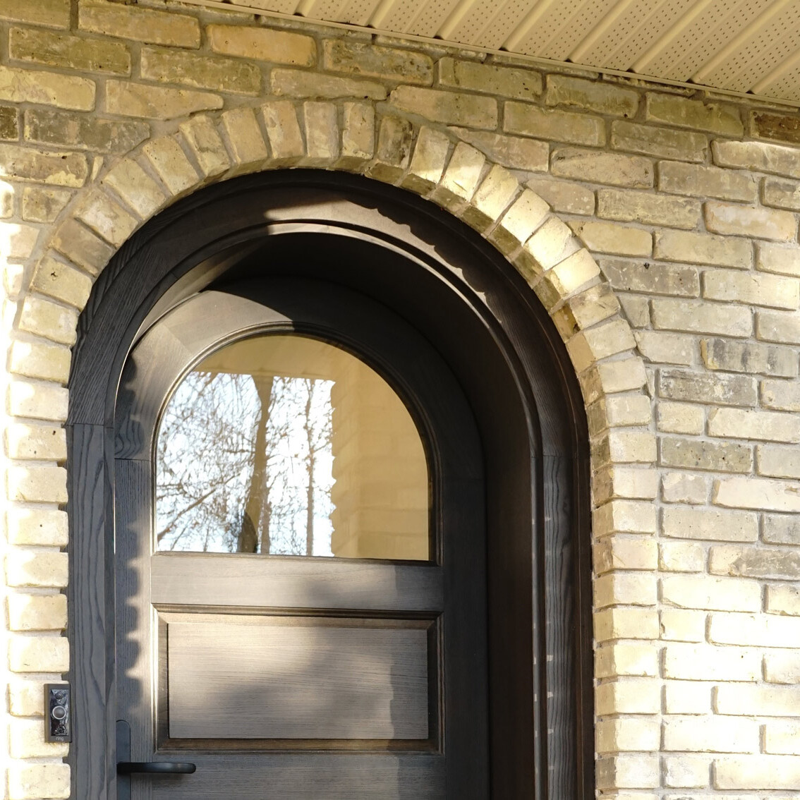 Wooden entrance doorway on brick wall