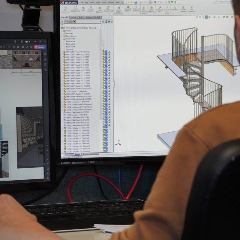 Estate Millwork employee builds staircase design on computer