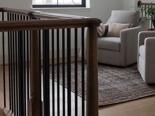 Dark brown, wooden railing in house